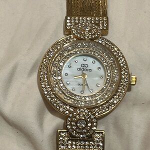 Aldora gold-toned women's quartz watch with a mesh band